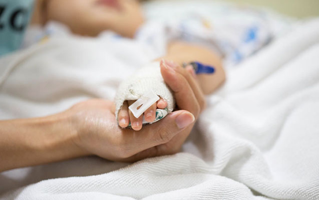 Mother holding a baby hand.